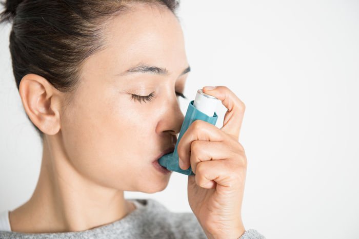 Person using an inhaler