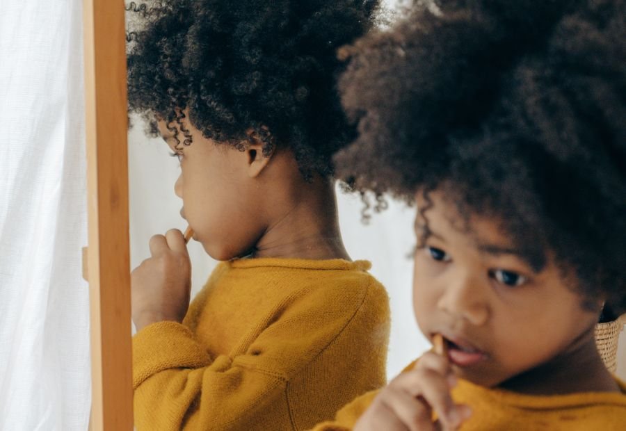 Child happily brushing teeth