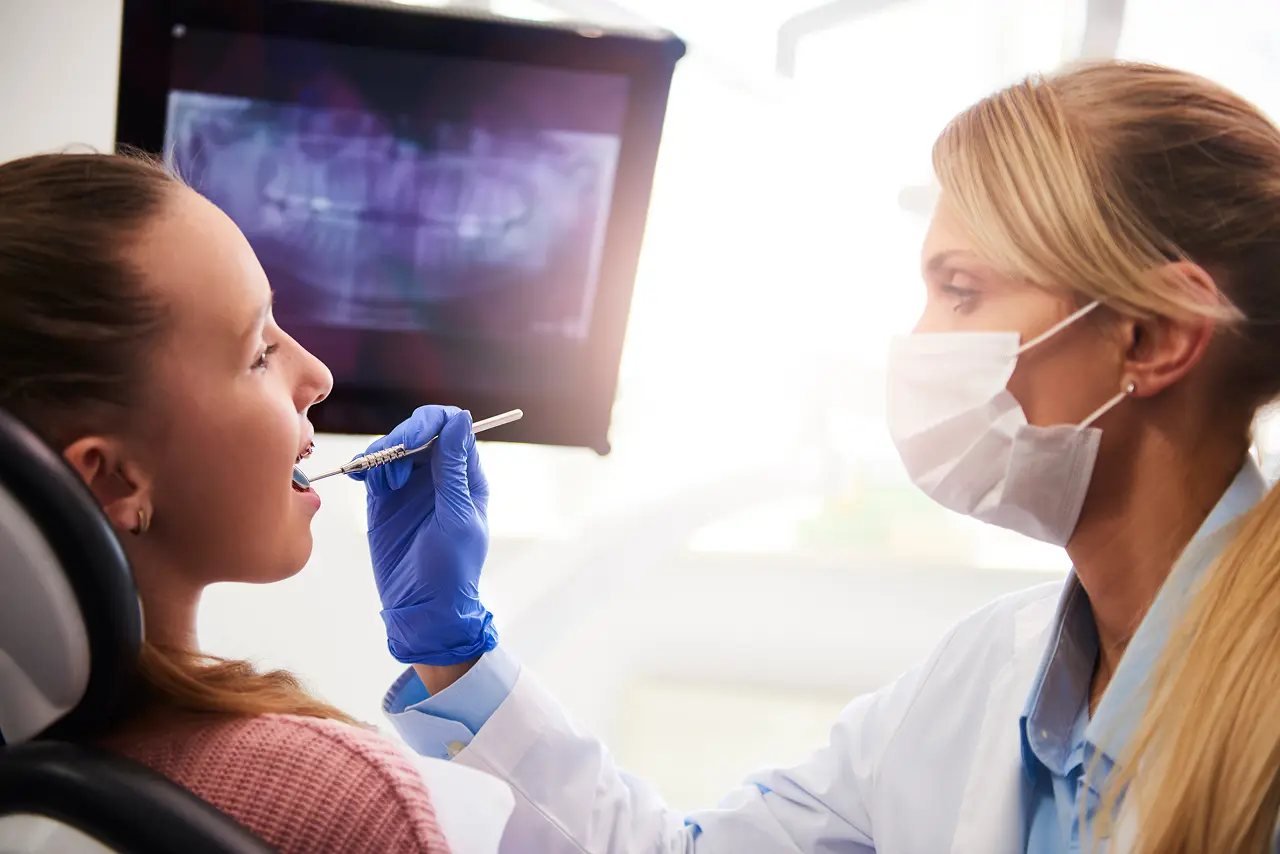 Dentist examining a patient’s mouth and jaw structure during an airway evaluation for sleep apnea