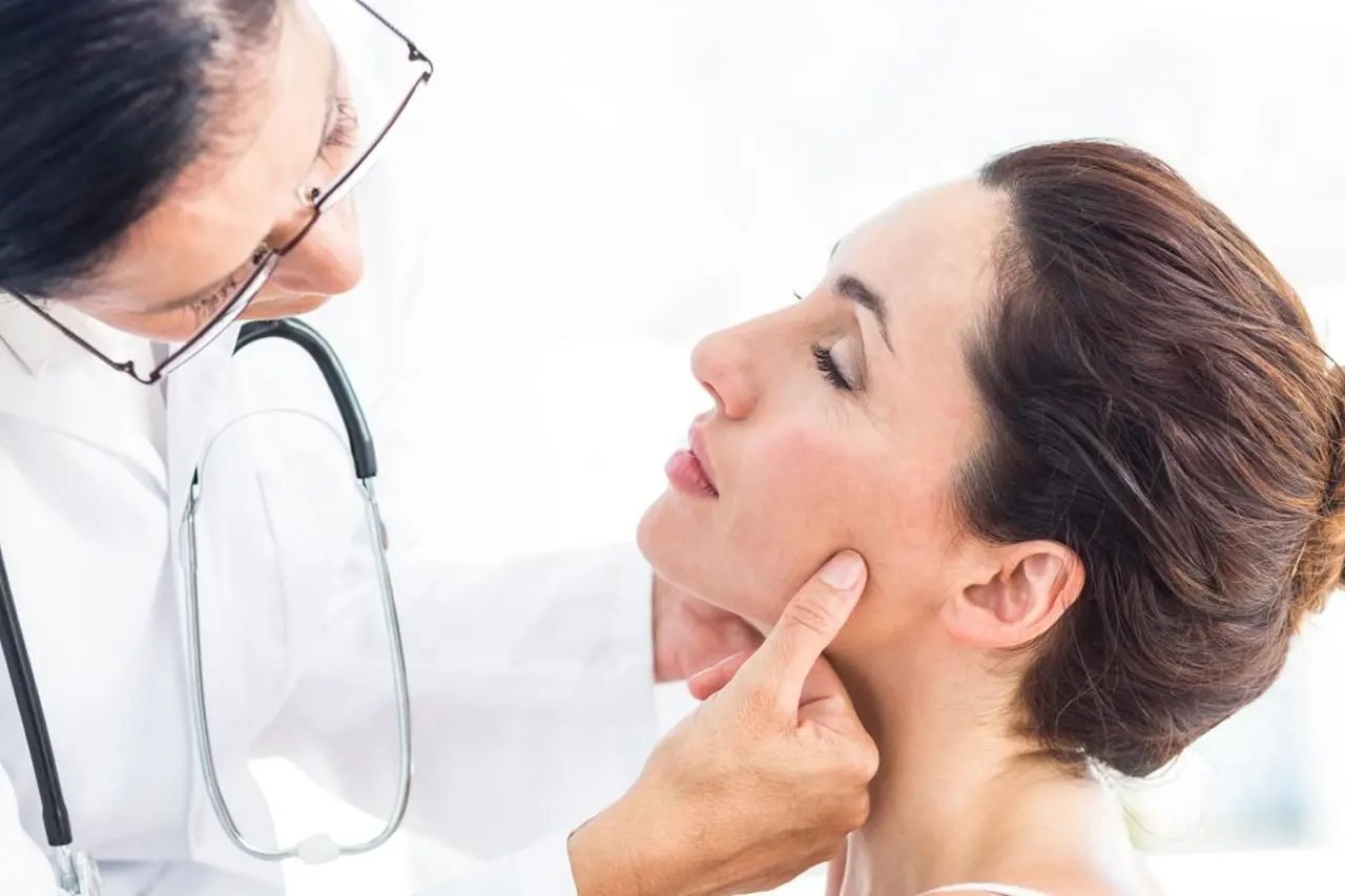 Doctor examining a patient’s jaw and temporomandibular joint during an airway and facial pain evaluation