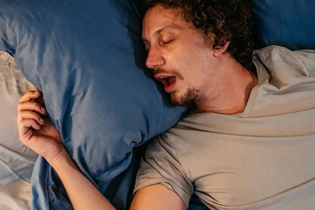 Adult man sleeping with his mouth open, illustrating mouth breathing while sleeping
