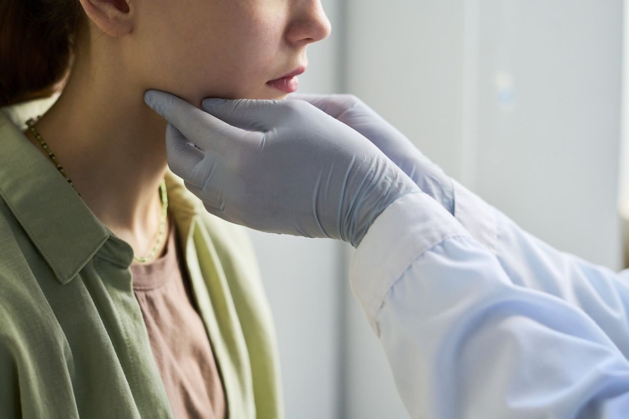 Provider examining a patient's jaw at Breathing Wellness Orlando