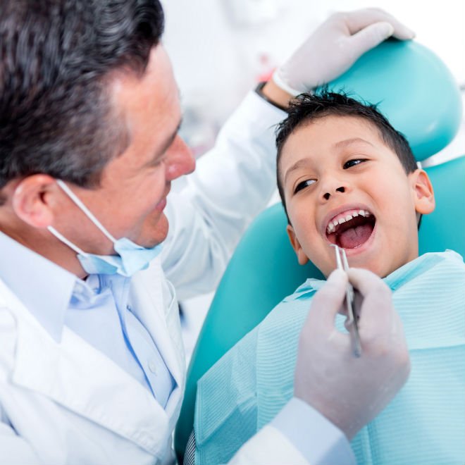 Dentist examining a child's airway and teeth
