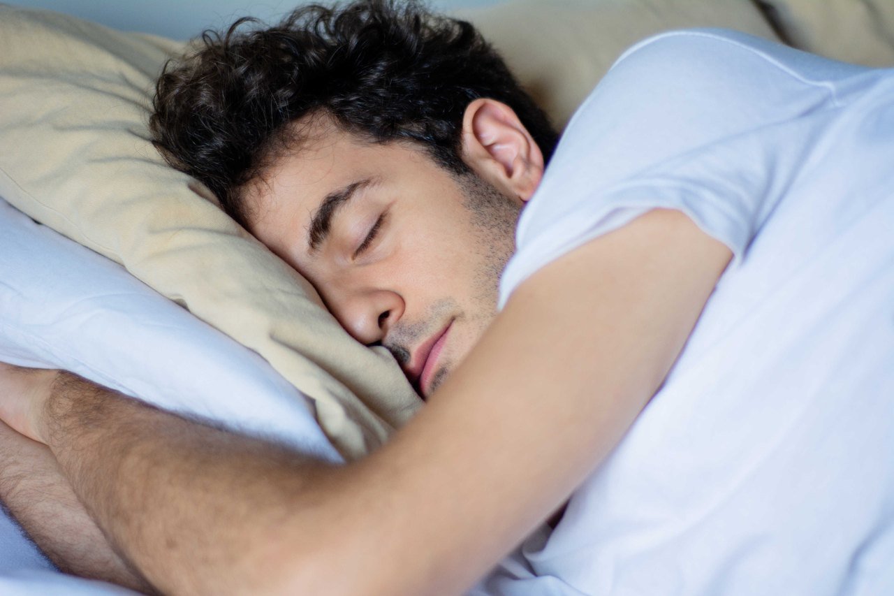 Man asleep in bed at night with his mouth slightly open