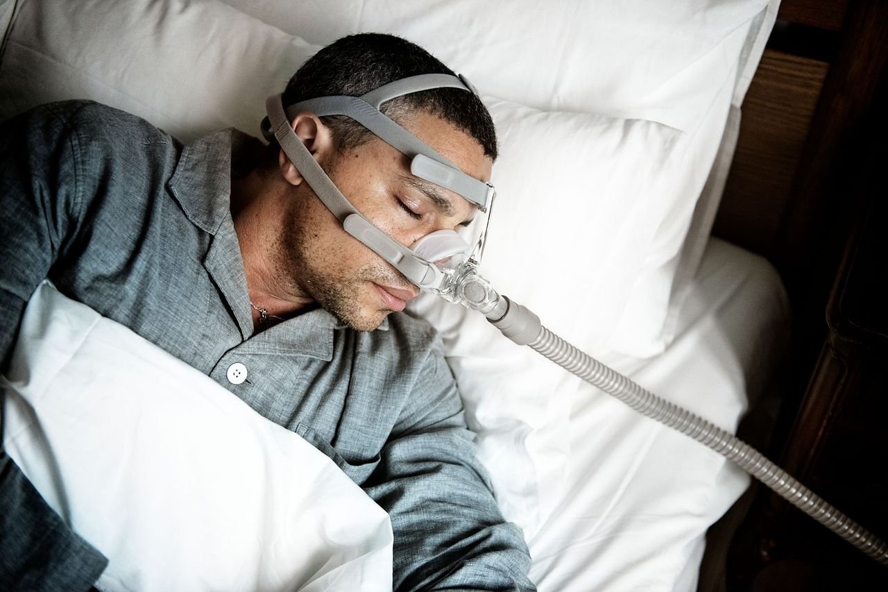 Man sleeping with a CPAP mask over his nose