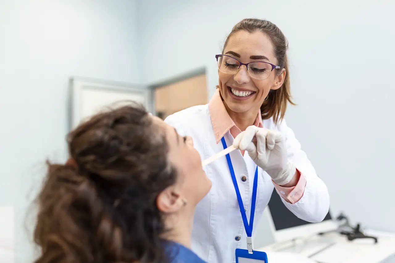 Airway health exam for Vivos sleep apnea treatment Dental professional performing a thorough oral exam to assess airway health for Vivos treatment